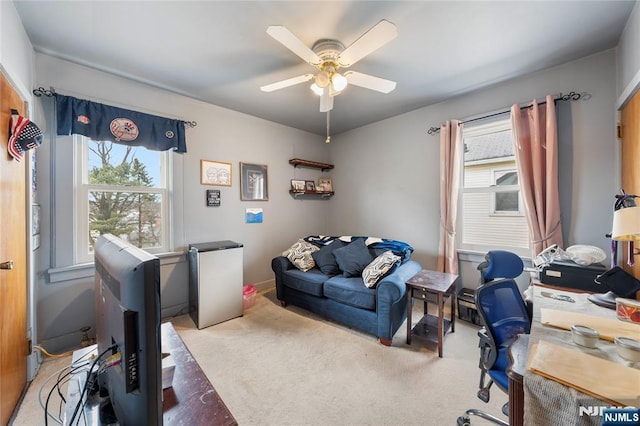 carpeted office featuring a ceiling fan