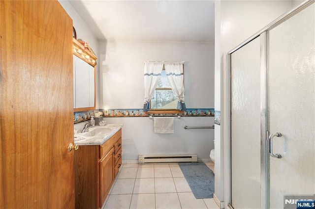 full bath featuring toilet, vanity, baseboard heating, a shower stall, and tile patterned floors