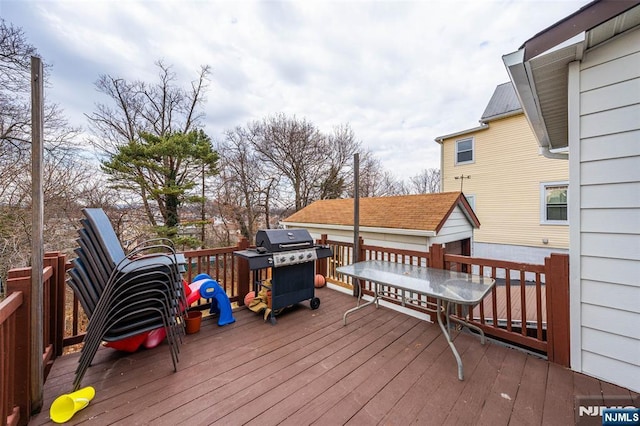 deck featuring an outbuilding and grilling area