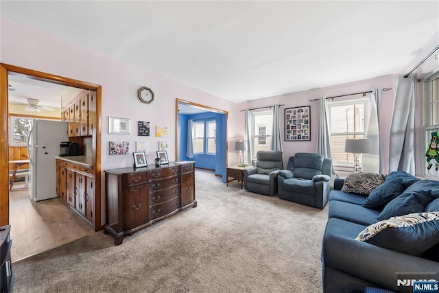 living room with a healthy amount of sunlight and light colored carpet