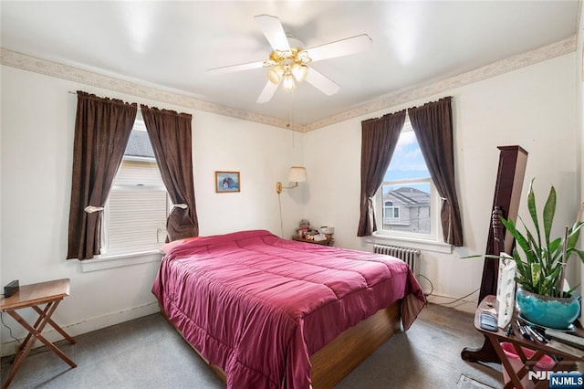 carpeted bedroom featuring a ceiling fan, radiator, and baseboards