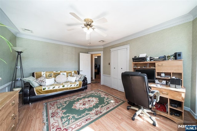 office space featuring wood finished floors, baseboards, visible vents, ceiling fan, and ornamental molding