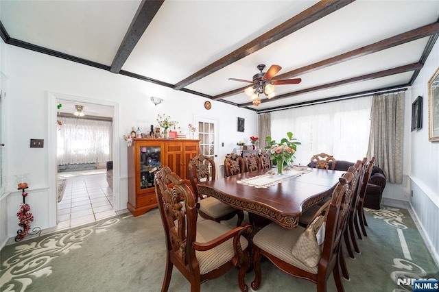 dining room featuring ceiling fan, beamed ceiling, light carpet, and light tile patterned flooring