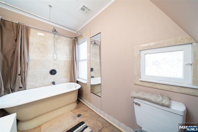 bathroom with visible vents, shower / bath combo, crown molding, tile walls, and toilet