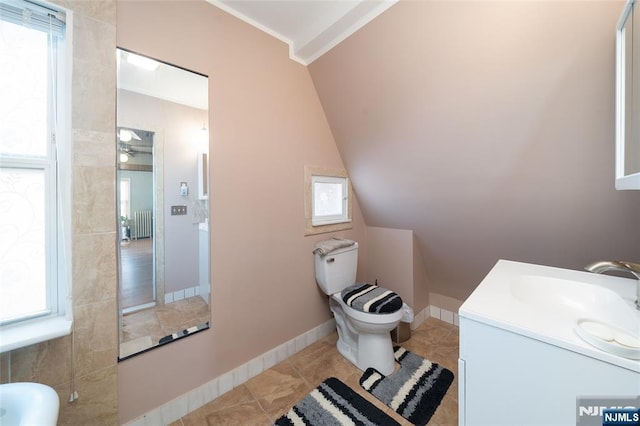 bathroom featuring radiator, baseboards, toilet, lofted ceiling, and vanity