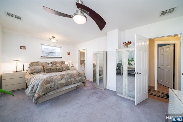 carpeted bedroom featuring visible vents and ceiling fan