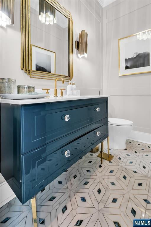 bathroom featuring vanity and toilet