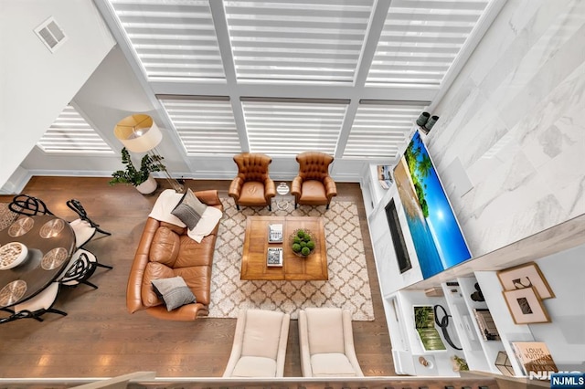 living room with visible vents and wood finished floors