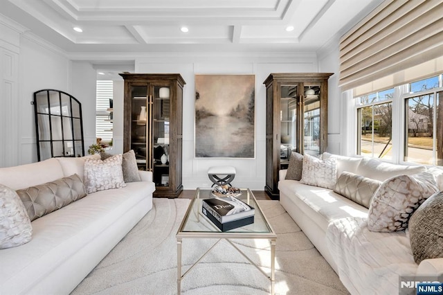 living area featuring recessed lighting, beam ceiling, coffered ceiling, and a decorative wall