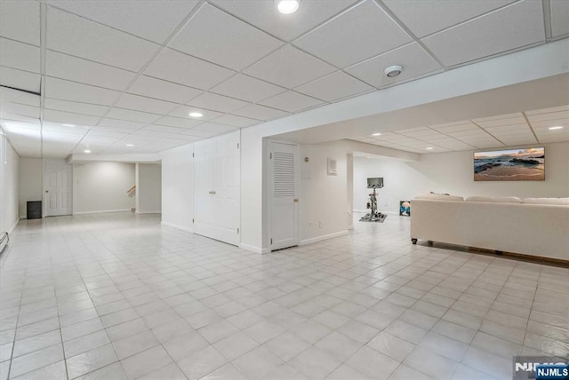 finished below grade area featuring recessed lighting, a drop ceiling, and baseboards