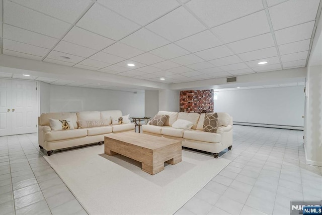 living room featuring baseboard heating, a drop ceiling, and recessed lighting