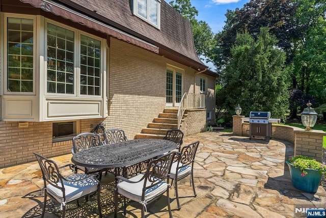 view of patio featuring area for grilling and outdoor dining space