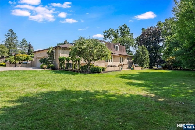 exterior space with brick siding, a lawn, and an attached garage