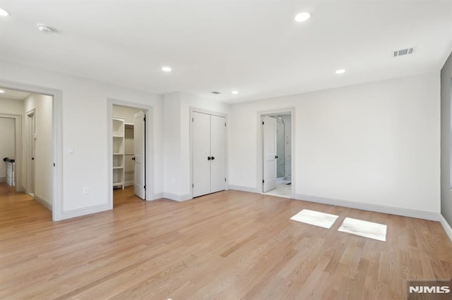 unfurnished bedroom with recessed lighting, light wood-style floors, visible vents, and baseboards