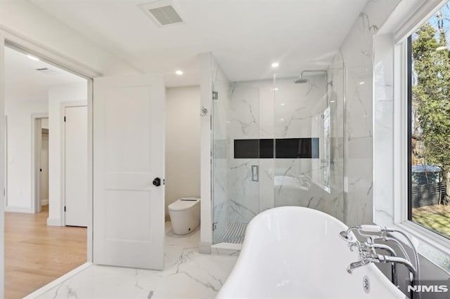 full bath featuring a marble finish shower, visible vents, marble finish floor, and a freestanding bath