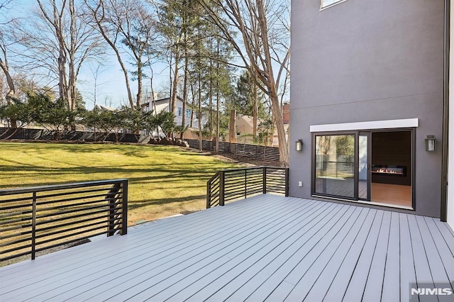 wooden deck with a yard and fence