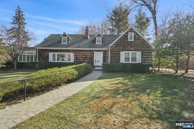 view of front facade with a front lawn and a chimney