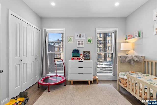 bedroom with recessed lighting, a closet, and wood finished floors