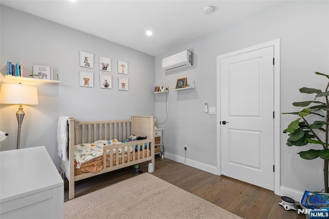 bedroom with recessed lighting, baseboards, wood finished floors, and a wall mounted AC