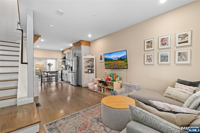 living area with dark wood-type flooring, stairway, visible vents, and recessed lighting