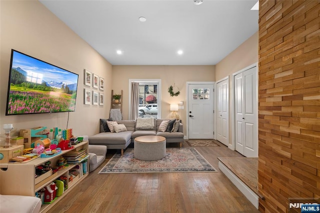 living area featuring wood finished floors and recessed lighting