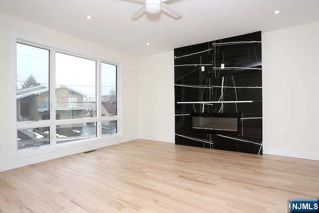 unfurnished room with wood finished floors, a ceiling fan, and recessed lighting