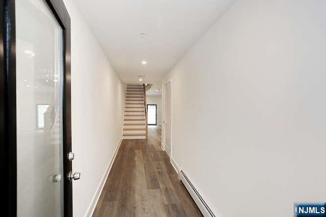 hall with dark wood finished floors, baseboards, and stairs