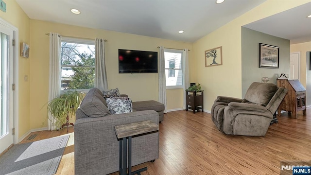 living area featuring plenty of natural light, wood finished floors, and baseboards