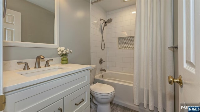 bathroom with shower / bath combo with shower curtain, toilet, and vanity