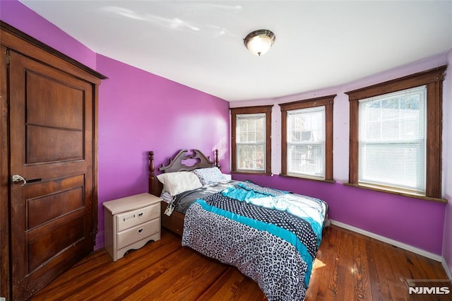 bedroom featuring baseboards and wood finished floors