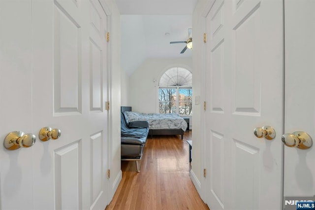 bedroom with light wood-type flooring, ceiling fan, and lofted ceiling