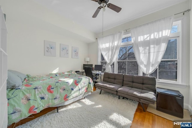 bedroom featuring a ceiling fan and wood finished floors