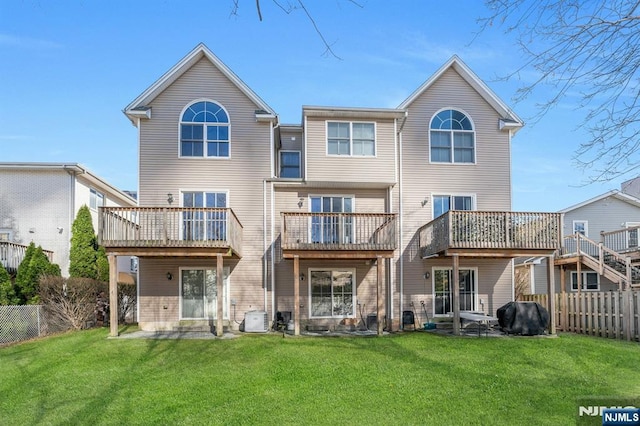 back of house with a yard, a fenced backyard, and cooling unit