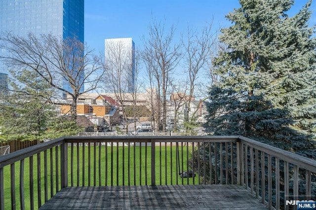 wooden terrace with a lawn