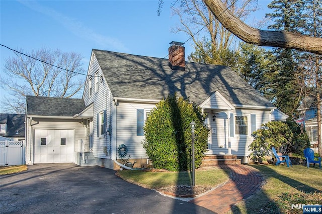 view of front of property with a shingled roof, a chimney, aphalt driveway, an attached garage, and fence