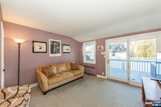 carpeted living area with lofted ceiling, baseboards, and radiator heating unit