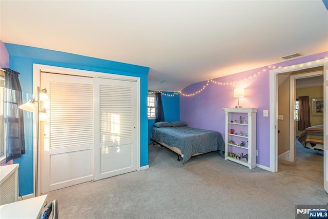 bedroom with baseboards, a closet, visible vents, and carpet flooring