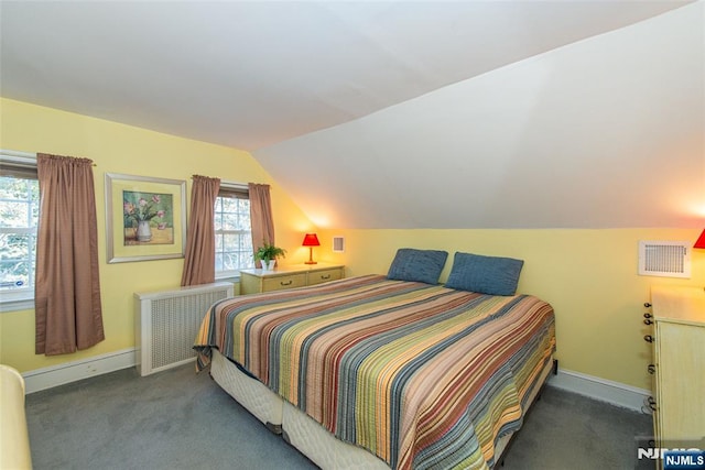 bedroom featuring radiator heating unit, visible vents, vaulted ceiling, and carpet flooring