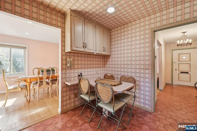 dining area with a notable chandelier, baseboards, and light tile patterned floors