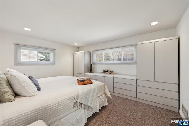 carpeted bedroom with multiple windows, visible vents, and recessed lighting