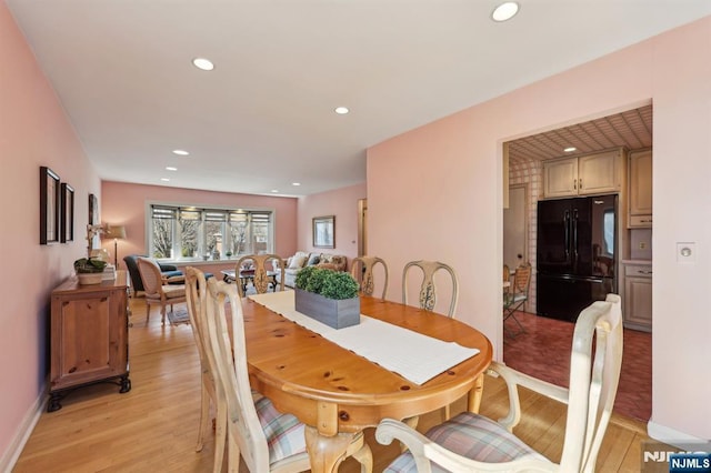 dining room with light wood-type flooring, baseboards, and recessed lighting