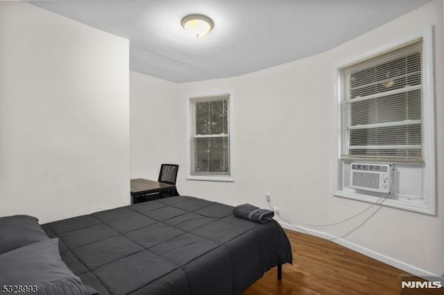 bedroom featuring baseboards and wood finished floors