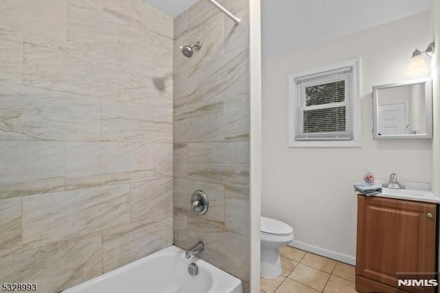 bathroom with shower / washtub combination, toilet, vanity, baseboards, and tile patterned floors