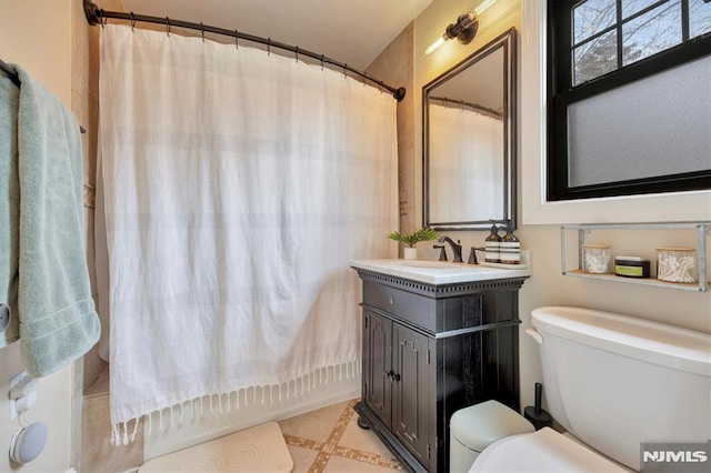 bathroom with shower / bath combination with curtain, vanity, and toilet