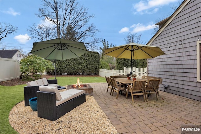 view of patio / terrace featuring outdoor dining area, a fenced backyard, and a fire pit