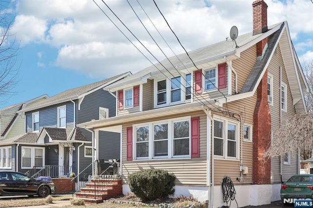 view of front of house with a chimney and a residential view