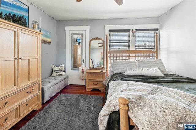 bedroom with a ceiling fan and dark wood-type flooring