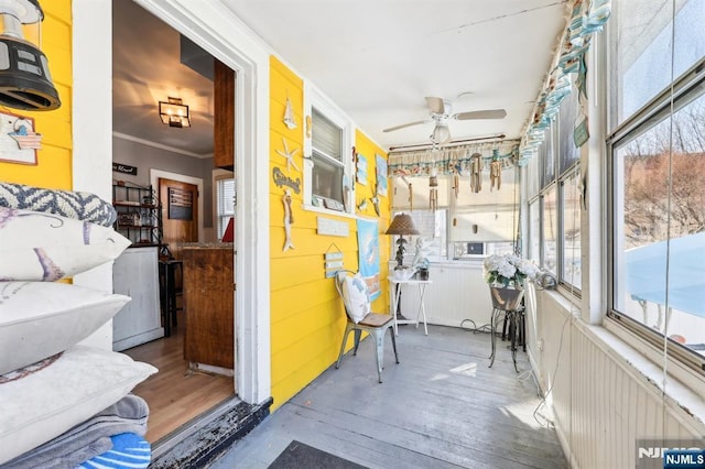 sunroom with a ceiling fan and a healthy amount of sunlight