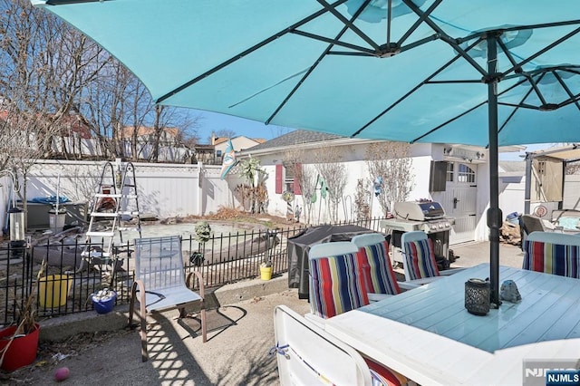 view of patio / terrace featuring outdoor dining area, a fenced backyard, and a grill