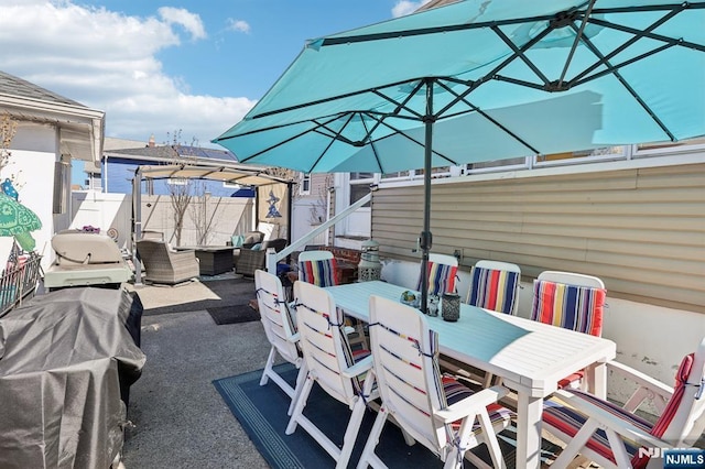 view of patio / terrace with outdoor dining space, fence, and an outdoor living space